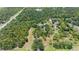 An aerial view of a secluded homesite surrounded by lush trees and a winding drive at 140 Cowpen Ln, Sarasota, FL 34240