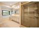 Bathroom with double sink vanity, large window, soaking tub, and walk-in shower at 140 Cowpen Ln, Sarasota, FL 34240