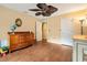 Bedroom featuring hardwood floors, two windows, and a vintage dresser at 140 Cowpen Ln, Sarasota, FL 34240