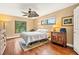 Bedroom with hardwood floors, ceiling fan, and natural light at 140 Cowpen Ln, Sarasota, FL 34240