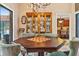 Dining room with chandelier and built-in china cabinet with a view of the kitchen at 140 Cowpen Ln, Sarasota, FL 34240