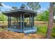 Charming gazebo with seating, a perfect spot to relax and enjoy the serene surroundings at 140 Cowpen Ln, Sarasota, FL 34240