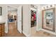 Hallway leading to a dining room and walk-in closet with ample storage and tile flooring at 140 Cowpen Ln, Sarasota, FL 34240