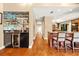 Hallway view of the kitchen with a wine bar and hardwood floors at 140 Cowpen Ln, Sarasota, FL 34240