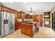 Kitchen featuring a center island, wooden cabinetry, and stainless steel refrigerator at 140 Cowpen Ln, Sarasota, FL 34240
