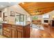 Spacious living room featuring wood ceilings, a fireplace, and backyard views at 140 Cowpen Ln, Sarasota, FL 34240