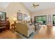 Open living room features hardwood floors, high ceilings, and sliding glass doors to the lanai at 140 Cowpen Ln, Sarasota, FL 34240