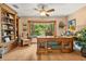 Charming office with hardwood floors, custom wood desk, and bay window with beautiful outdoor views at 140 Cowpen Ln, Sarasota, FL 34240