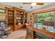 Charming office with hardwood floors, custom wood desk, and custom built-in shelving at 140 Cowpen Ln, Sarasota, FL 34240