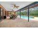 Covered patio featuring an outdoor dining area with a view of the luxurious pool and spa at 140 Cowpen Ln, Sarasota, FL 34240