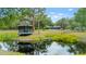 Scenic pond with a gazebo, creating a tranquil and picturesque setting at 140 Cowpen Ln, Sarasota, FL 34240