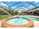 A luxurious pool and spa are enclosed in a screened lanai, perfect for relaxation and entertainment at 140 Cowpen Ln, Sarasota, FL 34240