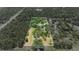 Aerial view highlighting property boundaries surrounded by lush, mature trees at 140 Cowpen Ln, Sarasota, FL 34240