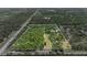 Aerial view highlighting the property lines, lush trees, and convenient road access at 140 Cowpen Ln, Sarasota, FL 34240