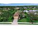 Aerial view of beautiful single-Gathering home with lush landscaping and a brick driveway at 1542 Ormond Ter, Parrish, FL 34219