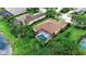 Aerial view of a beautiful home with a screened-in pool and well-maintained landscaping at 1542 Ormond Ter, Parrish, FL 34219