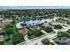Aerial view of community pond, well maintained lawns, and mature trees at 1542 Ormond Ter, Parrish, FL 34219