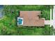 Aerial view of screened-in pool, lush landscaping, and a pond at 1542 Ormond Ter, Parrish, FL 34219