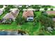 Backyard featuring screened-in lanai, well maintained lawn, and pond at 1542 Ormond Ter, Parrish, FL 34219