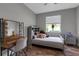 This bedroom features a bed, vanity, hardwood floors and a window at 1542 Ormond Ter, Parrish, FL 34219