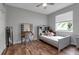This bedroom features a bed, vanity, hardwood floors and a window at 1542 Ormond Ter, Parrish, FL 34219
