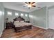 This bedroom has wood flooring and a ceiling fan and includes lots of natural light at 1542 Ormond Ter, Parrish, FL 34219