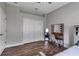 Bedroom featuring a vanity with lighted mirror, and wood-look flooring at 1542 Ormond Ter, Parrish, FL 34219