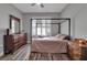 Bedroom featuring a four-poster bed, hardwood floors, and natural light at 1542 Ormond Ter, Parrish, FL 34219