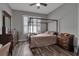 This bedroom features wood floors, shutters and a four-poster bed at 1542 Ormond Ter, Parrish, FL 34219