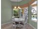 Bright breakfast nook with pool views and modern chandelier at 1542 Ormond Ter, Parrish, FL 34219