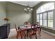 Dining room with classic wood furniture, chandelier, and natural light at 1542 Ormond Ter, Parrish, FL 34219