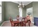 Formal dining room featuring classic wood furniture and overhead chandelier at 1542 Ormond Ter, Parrish, FL 34219