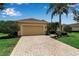 Charming home with a well-manicured lawn, mature landscaping, and a brick driveway at 1542 Ormond Ter, Parrish, FL 34219