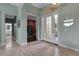 Bright foyer features neutral tile, white trim, arched doorways, and a glass front door at 1542 Ormond Ter, Parrish, FL 34219