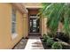 Inviting front entrance with brick walkway and lush landscaping provides curb appeal at 1542 Ormond Ter, Parrish, FL 34219