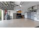 Organized garage with epoxy floors, storage cabinets, and a TV at 1542 Ormond Ter, Parrish, FL 34219