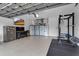 Garage with epoxy floors, overhead storage and a TV, creating a versatile space at 1542 Ormond Ter, Parrish, FL 34219
