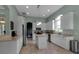 Light and bright kitchen featuring an island, stainless appliances, granite counters, and tile floors at 1542 Ormond Ter, Parrish, FL 34219