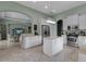 Spacious open-concept kitchen with an island, stainless appliances, and tile floors, next to the living area at 1542 Ormond Ter, Parrish, FL 34219