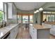 Well-lit kitchen with large windows, an island, neutral counters, stainless appliances, and tile floors at 1542 Ormond Ter, Parrish, FL 34219