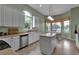 Kitchen with large island, tile floors, stainless appliances and view to dining area at 1542 Ormond Ter, Parrish, FL 34219