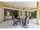 Covered lanai with comfortable seating and a view of the living room through sliding glass doors at 1542 Ormond Ter, Parrish, FL 34219
