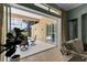 Covered lanai offering a glimpse of the pool and outdoor seating area through sliding glass doors at 1542 Ormond Ter, Parrish, FL 34219