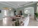 Open-concept living space with tile floors, neutral decor, and access to outdoor living at 1542 Ormond Ter, Parrish, FL 34219