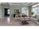 Open living room with tile floors, archways, and a view into the dining area at 1542 Ormond Ter, Parrish, FL 34219