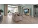 Bright living room with tile floors, a large window, and comfortable seating at 1542 Ormond Ter, Parrish, FL 34219
