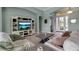Cozy living room featuring an entertainment center, tile floors, and views into the foyer at 1542 Ormond Ter, Parrish, FL 34219