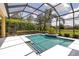 Gorgeous in-ground pool surrounded by screened enclosure and landscaped yard offers serene outdoor living space at 1542 Ormond Ter, Parrish, FL 34219