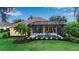 Gorgeous backyard with a pristine pool surrounded by lush landscaping and a screened enclosure at 1542 Ormond Ter, Parrish, FL 34219