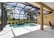 Spacious screened-in pool area with a spa and views of the surrounding landscape at 1542 Ormond Ter, Parrish, FL 34219